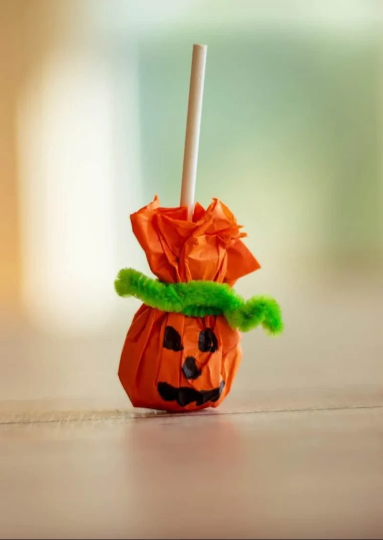Colorful lollipop pumpkins decorated for Halloween festivities.