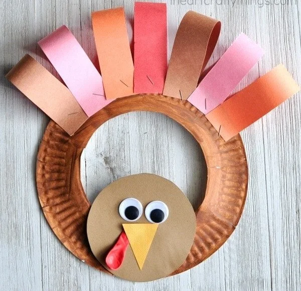 Colorful paper plate Thanksgiving turkey wreath craft for holiday decorations
